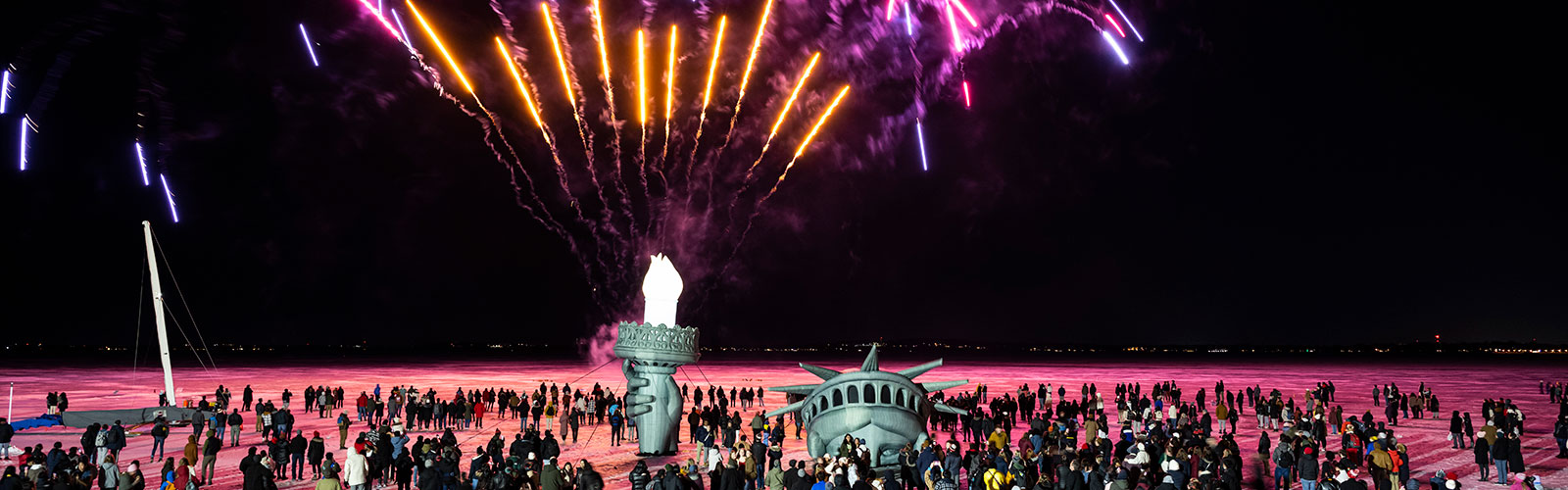 Hundreds of people watch as fireworks launch into the night sky above an inflatable replica of the Statue of Liberty’s head, arm and torch on frozen and ice-covered Lake Mendota during the conclusion of the Wisconsin Union’s Winter Carnival