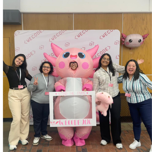 Students pose with someone in a pink animal costume
