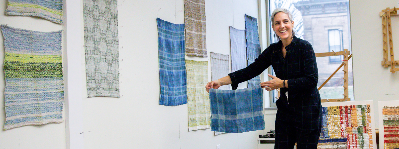 Professor Marianne Fairbanks displays a hand woven water cloth.