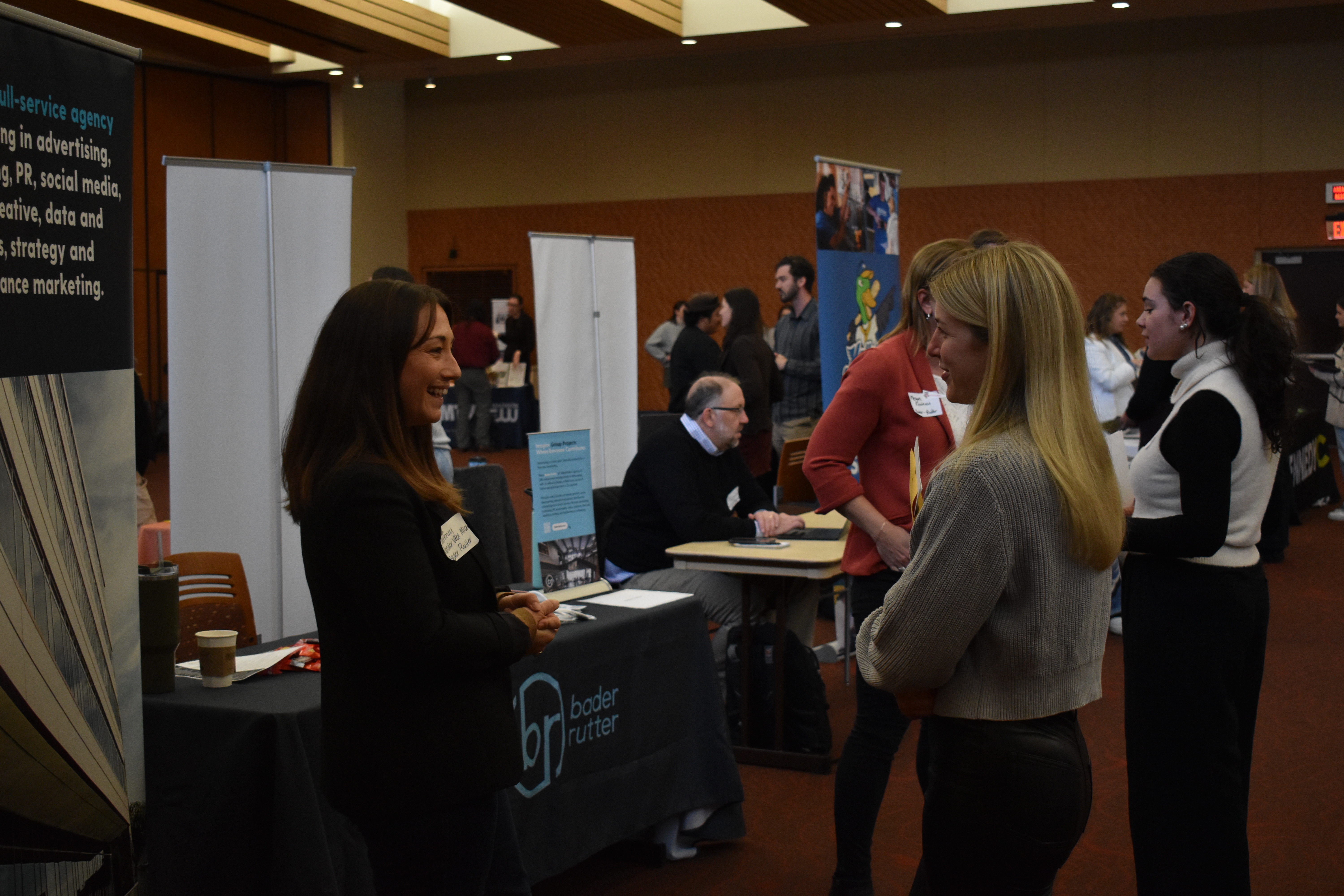 A student meets with an employer at the Advertising and Communications Career Fair
