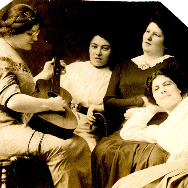 Yiddish author Miriam Karpilove entertains a group of women with music