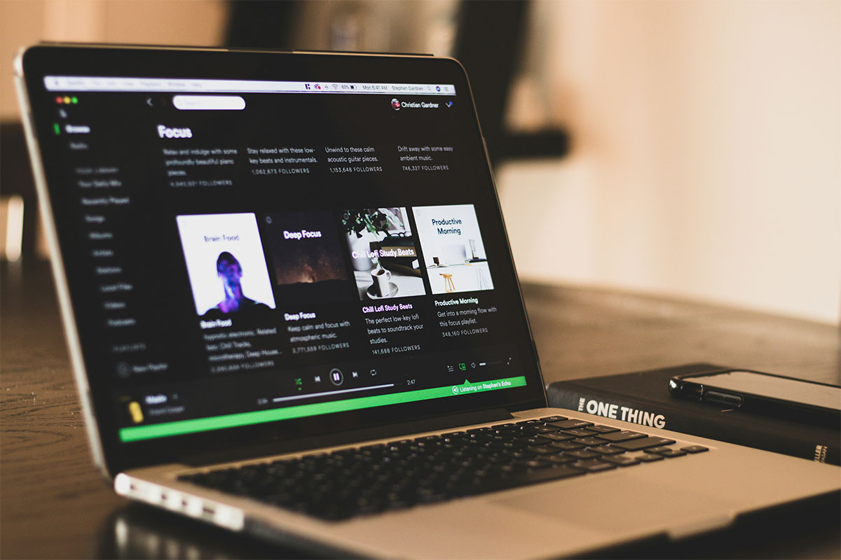 Laptop showing Spotify playlists.