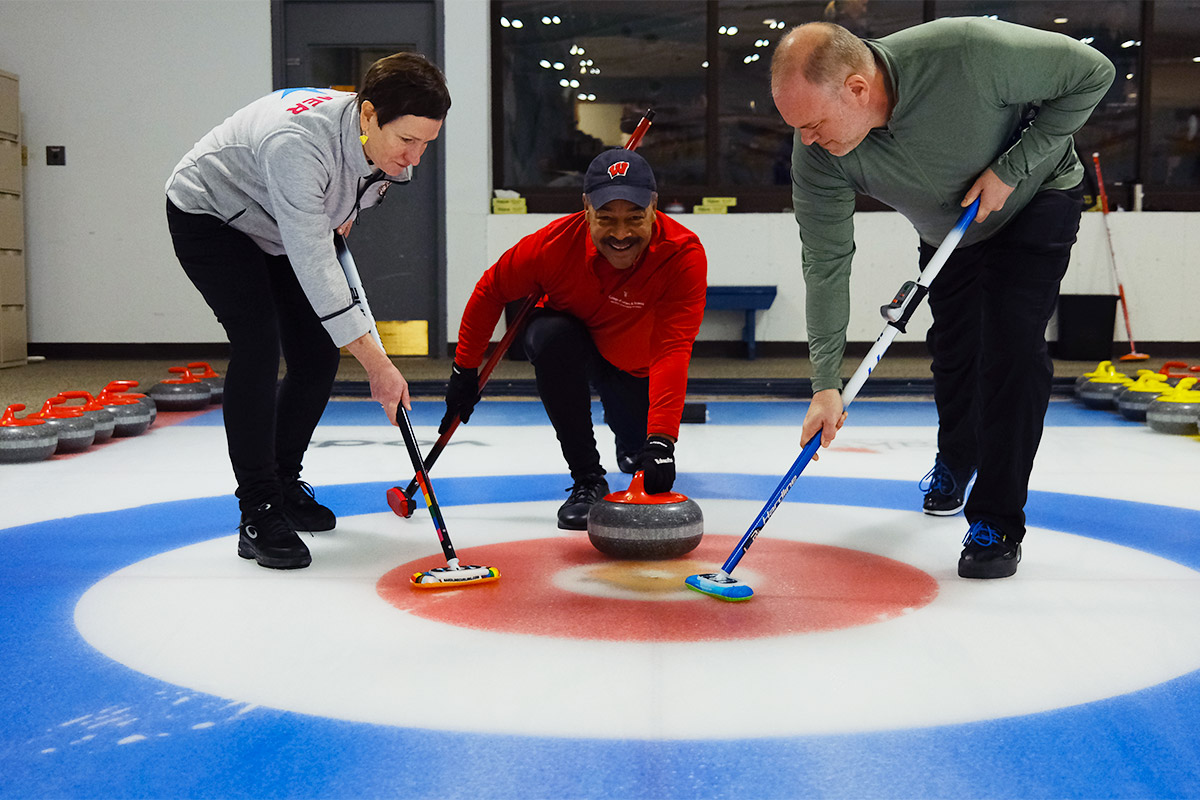 Dean Eric Wilcots curling with other L&S Staff.