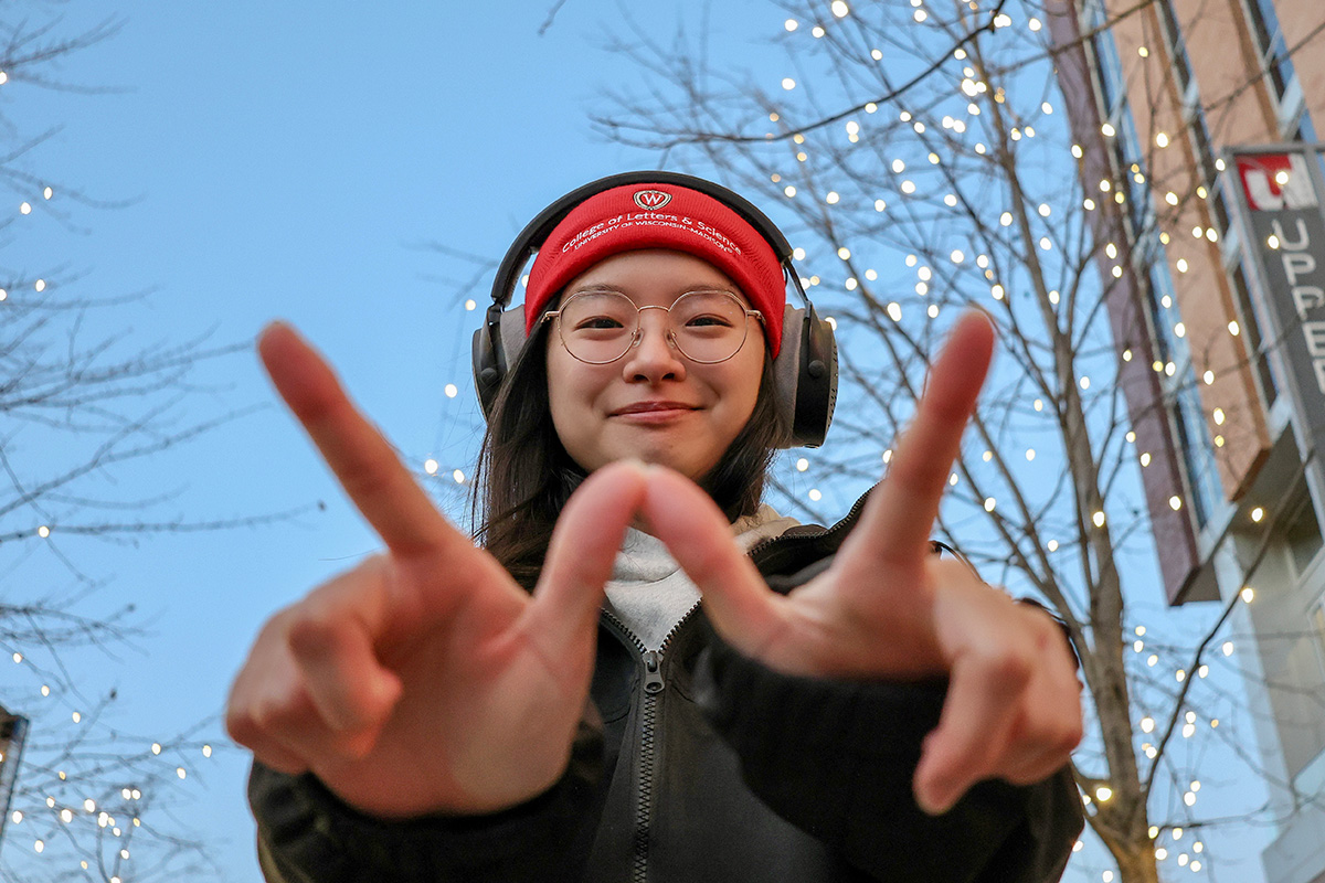 Student wearing L&S winter cap and headphones